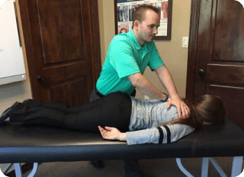 New patient receiving a consultation at a Tomball chiropractor's office, showcasing the initial assessment process in a welcoming environment.